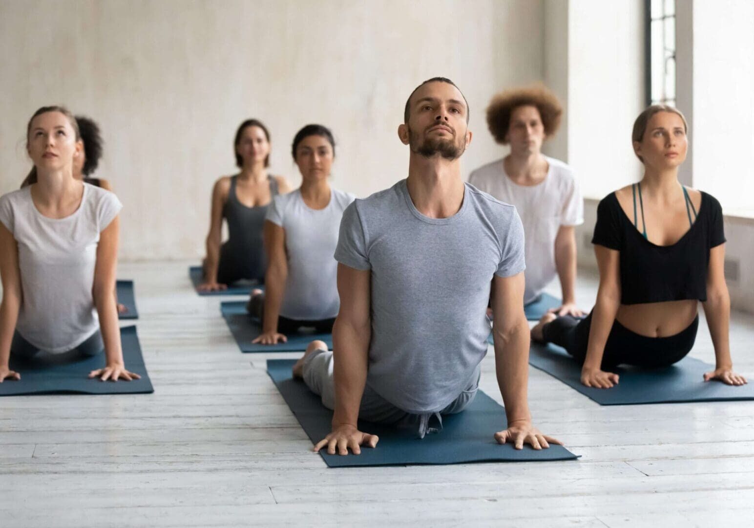 People practicing yoga in a studio class.